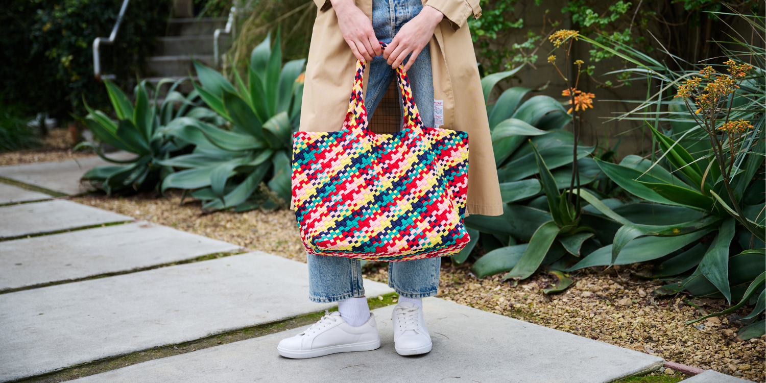 a model with a black tote bag