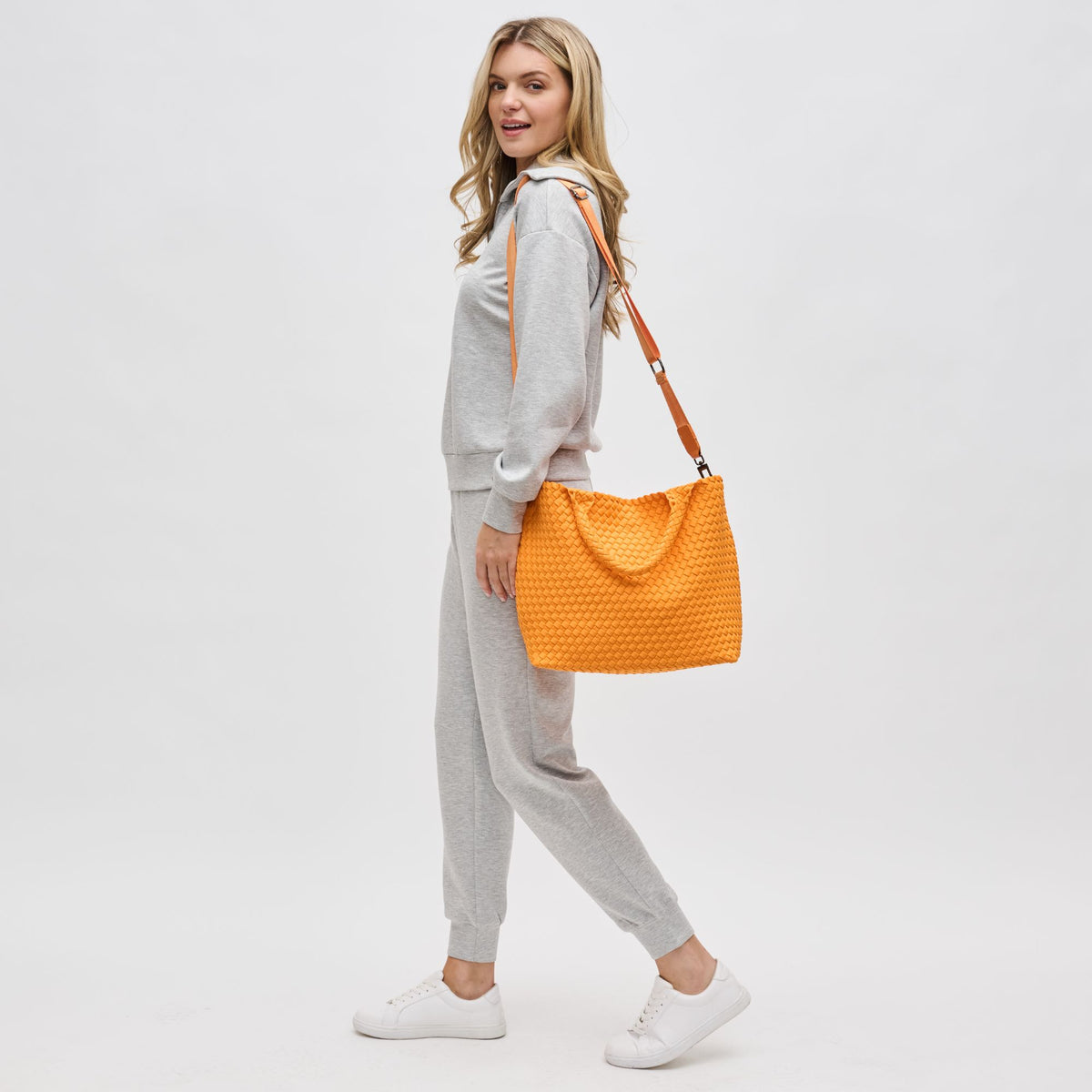 Woman wearing Orange Sol and Selene Sky&#39;s The Limit - Medium Orange Tote 841764111294 View 3 | Orange