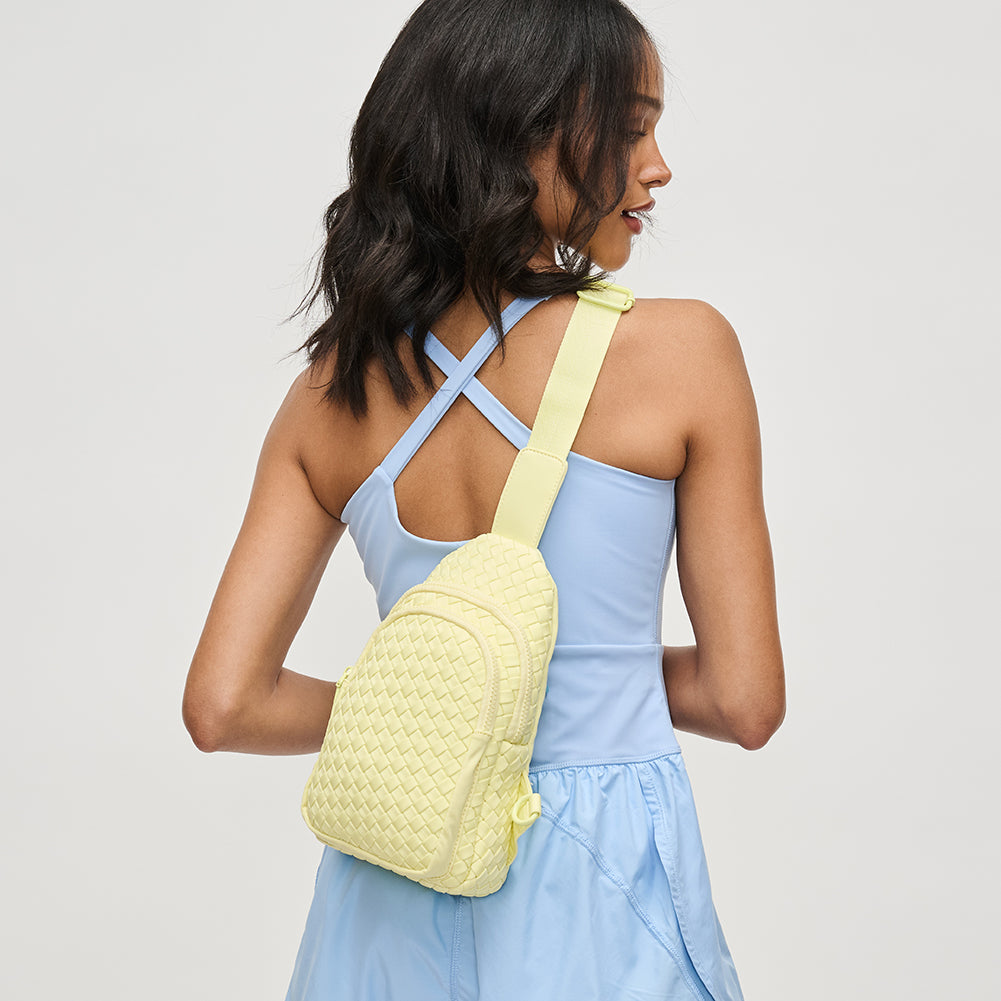 Woman wearing Butter Sol and Selene Beyond The Horizon - Woven Neoprene Sling Backpack 841764108034 View 3 | Butter