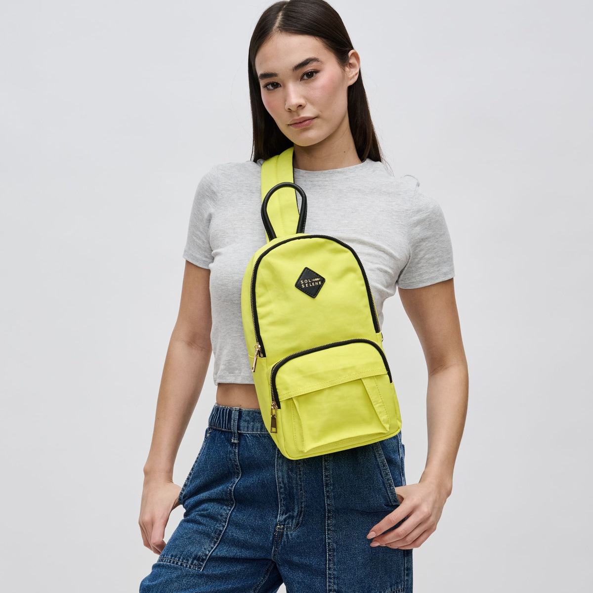 Woman wearing Yellow Sol and Selene Hustle Sling Backpack 841764106566 View 2 | Yellow