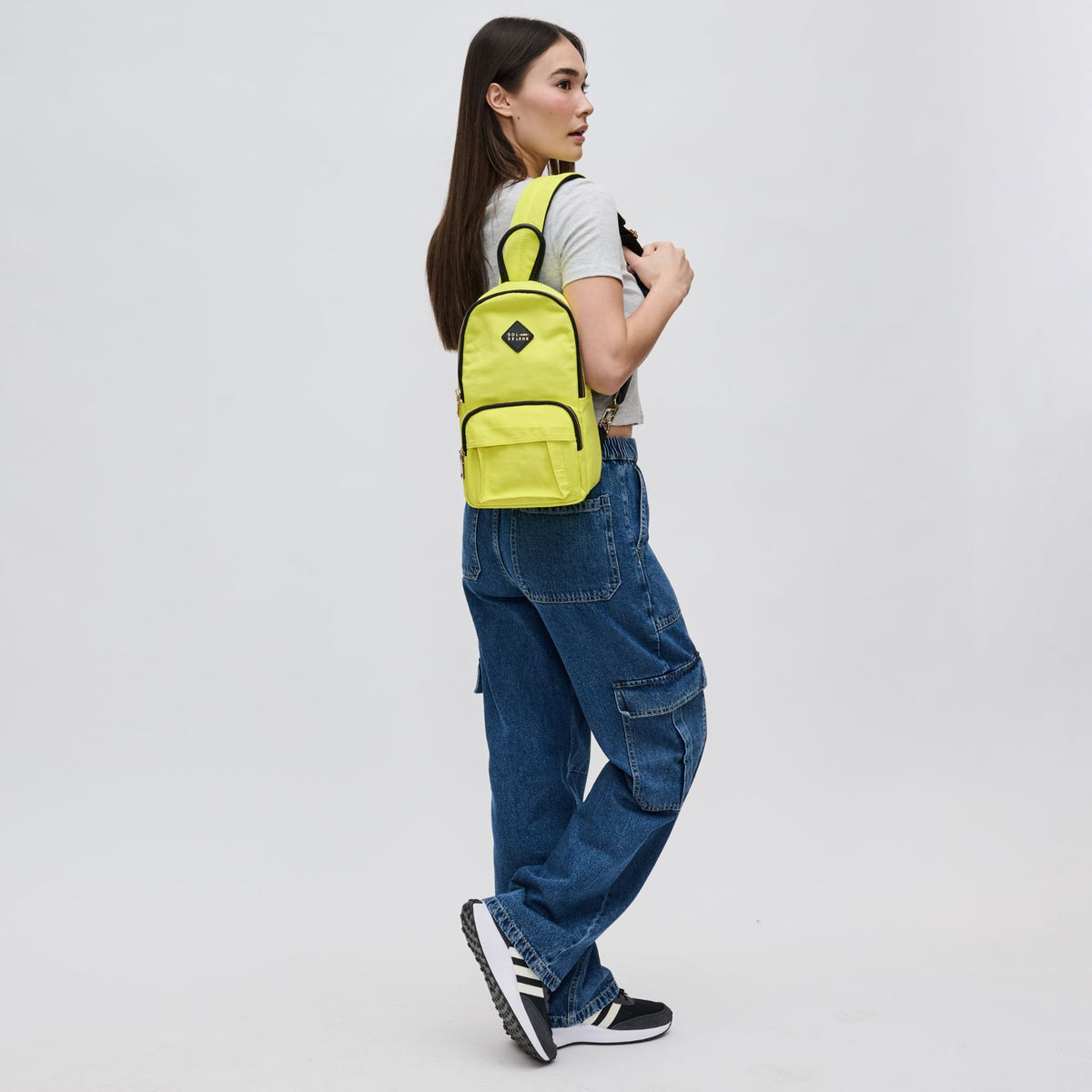 Woman wearing Yellow Sol and Selene Hustle Sling Backpack 841764106566 View 3 | Yellow