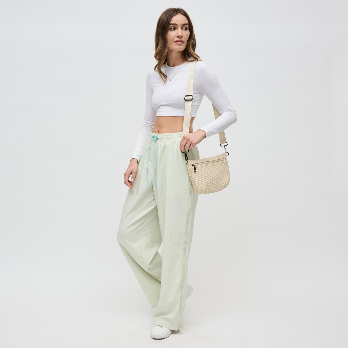 Woman wearing Cream Sol and Selene Ethereal - Woven Neoprene Crossbody 841764110846 View 3 | Cream