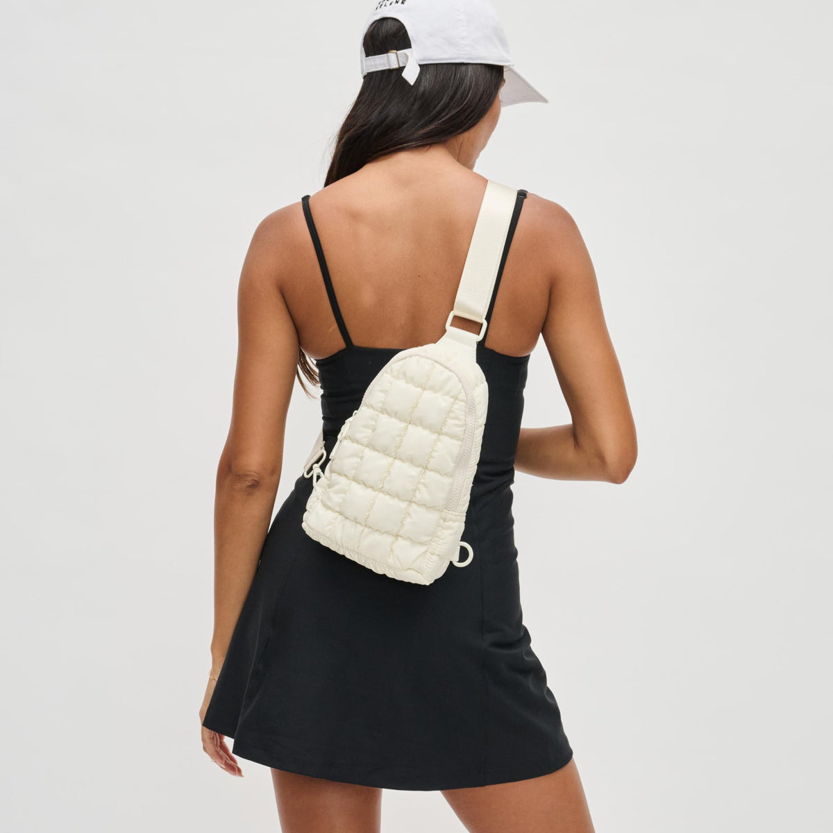 Woman wearing Ivory Sol and Selene Rejuvenate Sling Backpack 841764109604 View 1 | Ivory