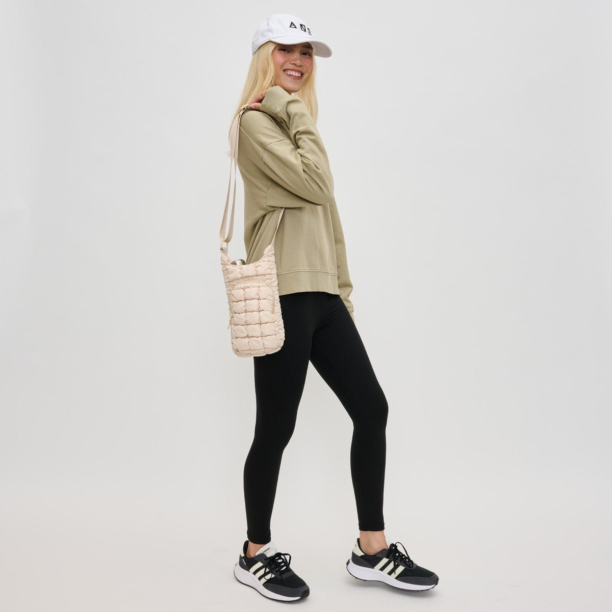 Woman wearing Cream Sol and Selene Let It Flow - Quilted Puffer Crossbody 841764110402 View 3 | Cream