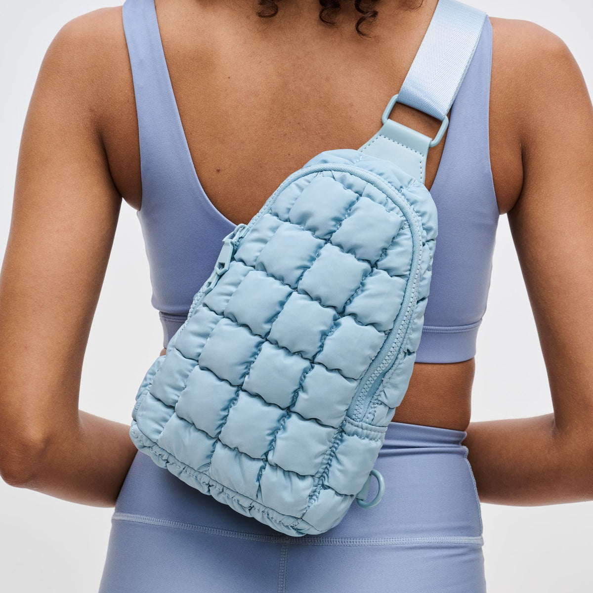 Woman wearing Sky Blue Sol and Selene Rejuvenate Sling Backpack 841764109567 View 4 | Sky Blue