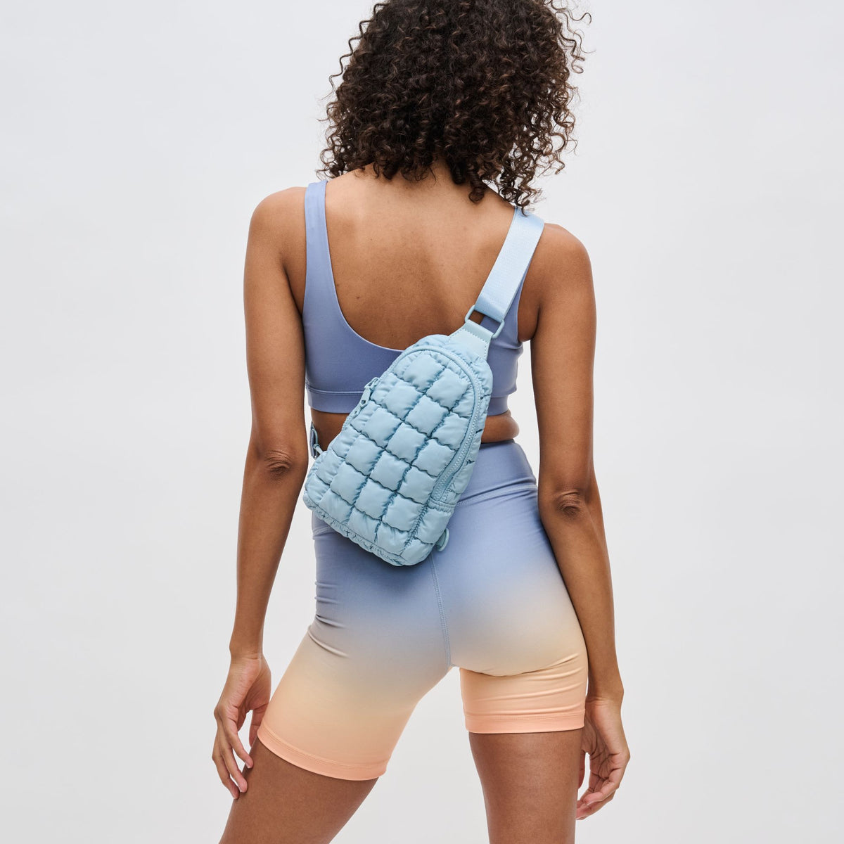 Woman wearing Sky Blue Sol and Selene Rejuvenate Sling Backpack 841764109567 View 2 | Sky Blue