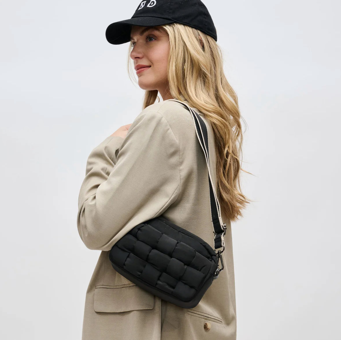 model wearing a black crossbody bag