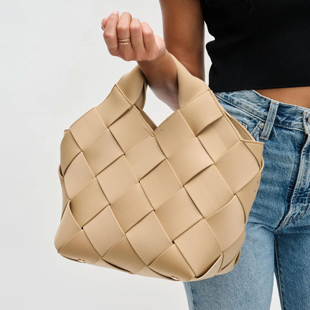 model carrying a nude woven handbag