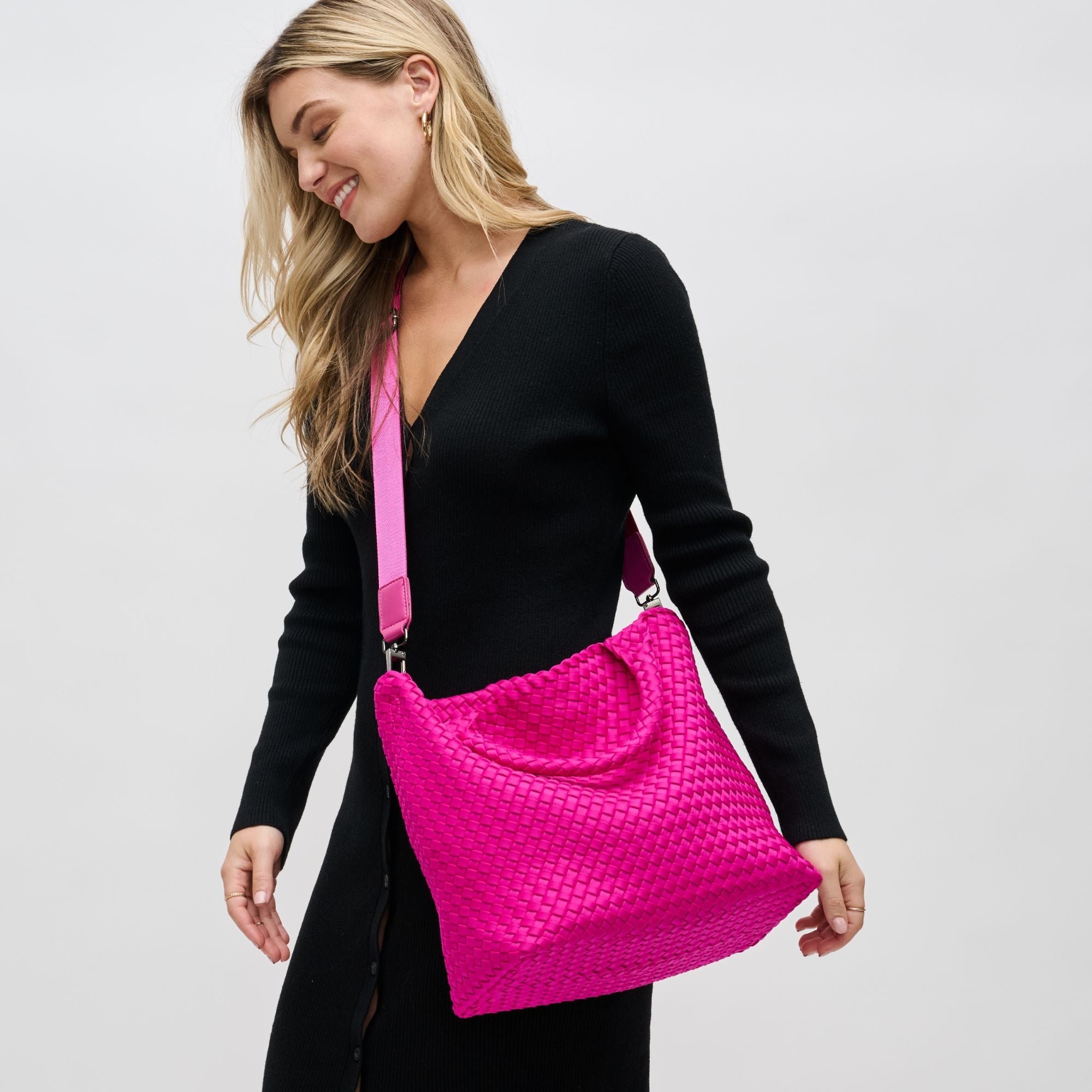 a model carrying a pink tote bag