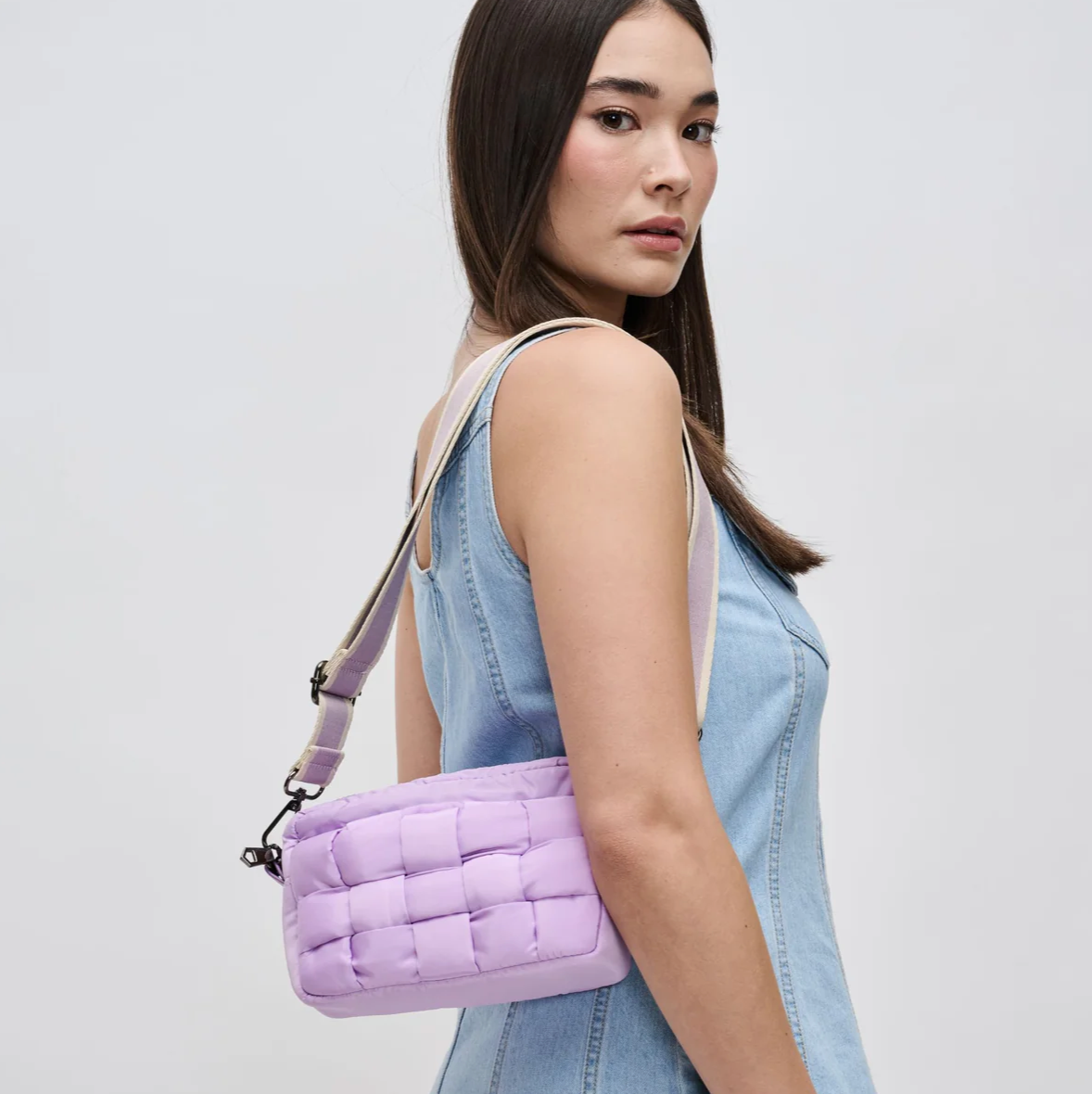 model wearing a purple crossbody bag