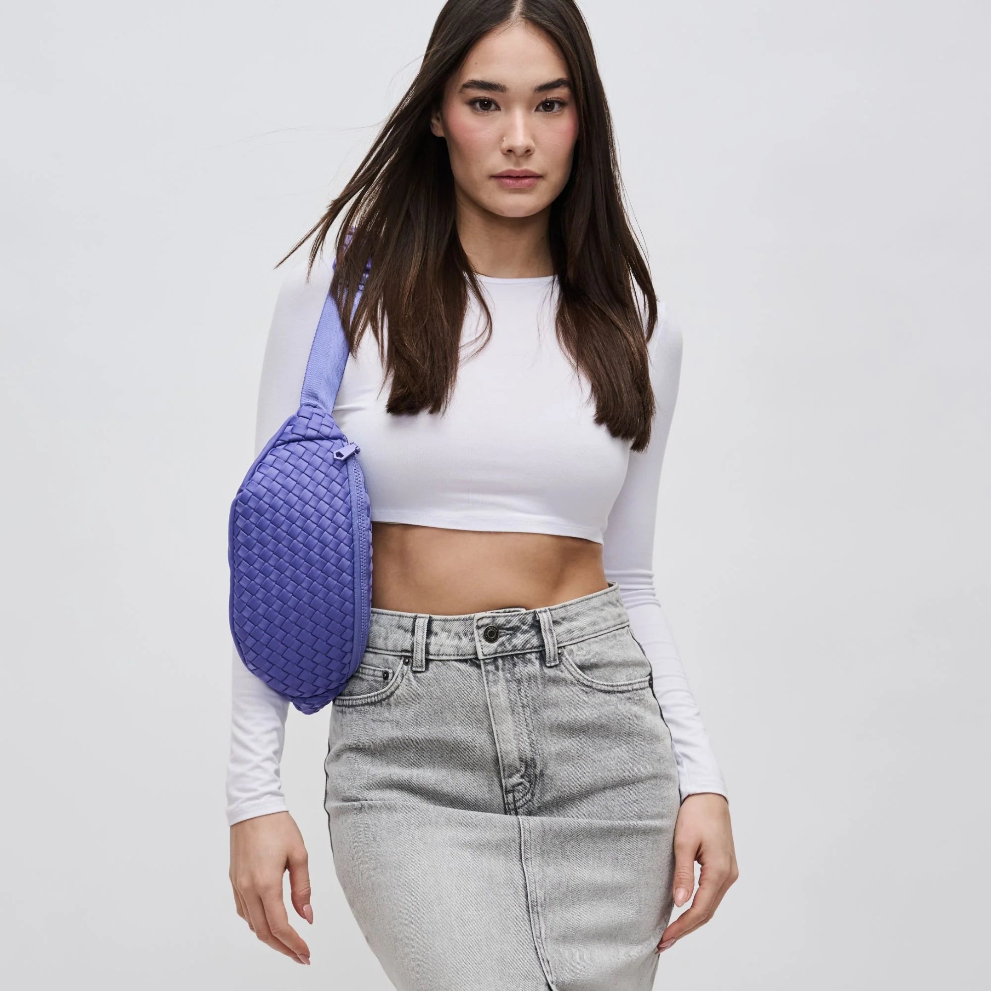 a model wearing a purple neoprene belt bag