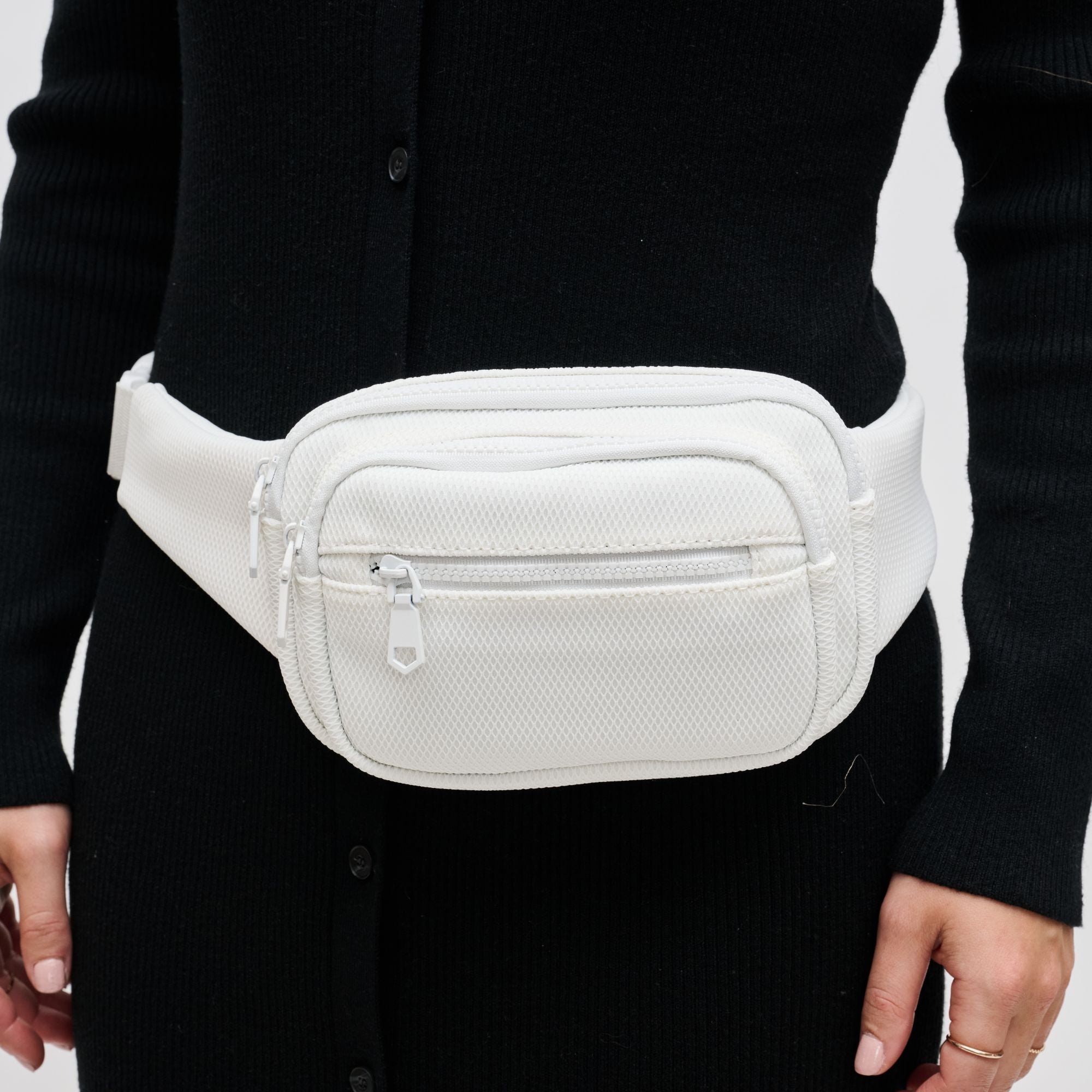 a model wearing a white mesh belt bag