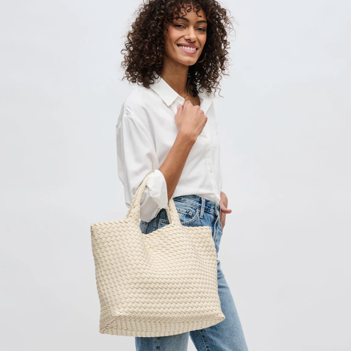 model carrying a woven tote bag